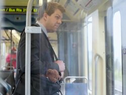 MS Well dressed young businessman riding on commuter train in urban area / Minneapolis, Minnesota, United States Stock Footage
