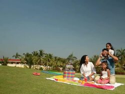 Family enjoying picnic in a park  Stock Footage