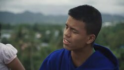 M/S group of Burmese teenagers playing music in the flat roof of an abandoned building Stock Footage