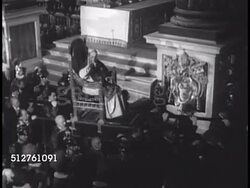 1950: VATICAN CITY: Pope Pius XII (1876-1958) being carried in sedia gestatoria (papal chair) through center of Basilica Sancti Petri (St. Peter's Basilica). Crowd of people in Basilica. Instructional Video