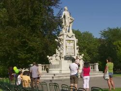 Statue of Wolfgang Amadeus Mozart in the Burggarten (Castle Garden) in Vienna  Stock Footage