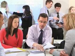 MS Students talking with Teacher and some students in front of whiteboard projection screen in background / Bristol, United Kingdom Stock Footage