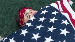 boy with an American flag thinking about winning Stock Footage