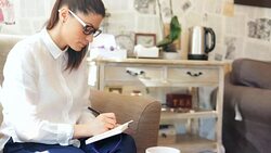 Woman taking notes. Stock Footage