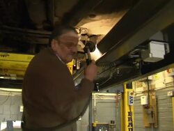 Mechanic performing MOT test on car News Clip