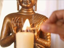 CU TU SLO MO Candle being lit up with buddha figure / Miami, Florida, United States Stock Footage