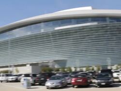  PAN Exterior of Cowboys Stadium arena from crowded parking lot / Arlington, Texas, United States Stock Footage