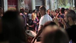 Crowd watches as happy man dances to Brazilian samba music on the streets of Rio Stock Footage