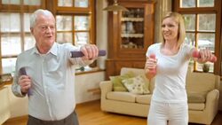 SLO MO senior man doing supervised exercises at home Stock Footage