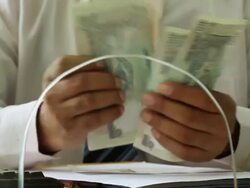 Bank Teller counting money at bank counter, Delhi, India Stock Footage
