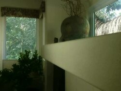 Medium static - A living room crumbles near a Tyrannosaurus rex in a computer-generated animation. / Denver, Colorado, USA Stock Footage