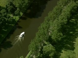 MS AERIAL PAN ZO DS View of boat moving on proper Canal / Flanders, Belgium Stock Footage