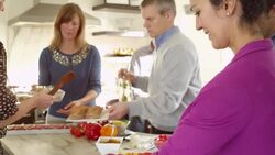 MS R/F Smiling mature couples preparing food together in home kitchen Stock Footage