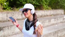 Young beautiful model woman listening music Stock Footage