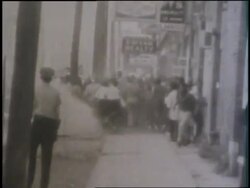 Police officers spray a crowd with a hose during the Birmingham race riots. News Clip