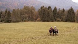AERIAL Two men riding their horses in countryside and talking Stock Footage