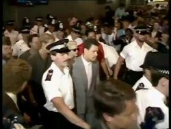1987 MS PAN Madonna walking through Heathrow Airport surrounded by police and photographers after arriving for British tour on August 13, 1987 / London, England / AUDIO Stock Footage