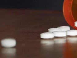 Pills pouring from a prescription drug bottle Stock Footage