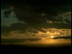 T/L Clouds moving right to left across sky, at sunset, horizon Stock Footage