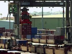  MS Gantry crane moving shipping container from freight rail car and drops container onto truck bed / San Pedro, California, United States Stock Footage