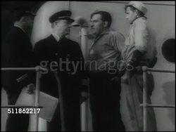 1937: MARITIME COMMISSION: WS Docked cargo ship, men working on deck. DRAMATIZATION: Union Delegate seaman demanding additional food & beer from captain, seamen Delegate calling for 'sit down strike' when refused, men stopping work on deck. Instructional Video