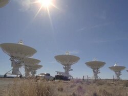  WS PAN View of truck pulling solar panel through Very Large Array / San Augustine, New Mexico, USA Stock Footage