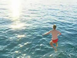 HD SLOW MOTION: Young Man Jumping Into The Sea Stock Footage