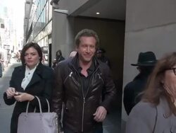 Joby Ogwyn, who will climb to the summit of Mount Everest this May, strap on a wing suit & jump right off it, exits the Today show in Rockefeller Center Stock Footage