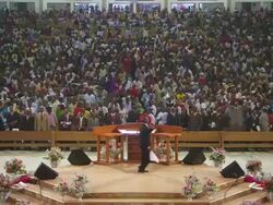 WS View of church service with people praying, singing and dancing / Lagos Church of Winners, Nigeria Stock Footage