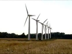 Man running towards row of wind turbines Stock Footage