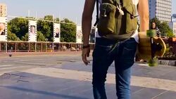 Man with longboard walking Stock Footage