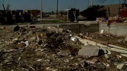 Debris from a tornado clutters the side of a road. Stock Footage