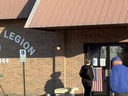 MS, TD Couple entering building through door with american flag on it, New Knoxville, Ohio, USA Stock Footage