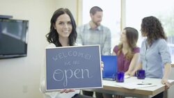 Small business startup company holding a 'We are Open' sign Stock Footage