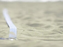 ECU of female beach volleyball players hand as she straightens out the line. Stock Footage