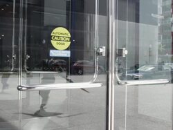 MS Young man dressed up in black suit and going into building / Minneapolis, Minnesota, United States Stock Footage