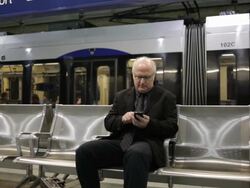 MS Middle aged businessman using cellular phone inside commuter transit station / Minneapolis, Minnesota, United States Stock Footage
