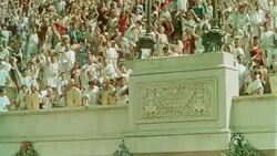 low angle PAN crowd of Romans cheering + throwing things in arena in ancient Rome / Quo Vadis (1951) Stock Footage