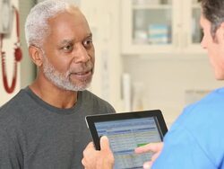 CU TU Nurse Reviewing Digital Patient Records with Senior Man / Richmond, Virginia, United States Stock Footage