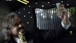 Celebrity snaps selfies with smartphone and kisses Oscar statuette in back of limousine at awards show Stock Footage