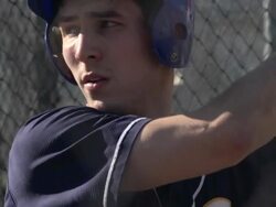 A young man practicing baseball at the batting cages.  - Slow Motion Stock Footage