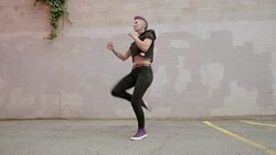 Cool young woman practicing martial arts kick in urban parking lot Stock Footage