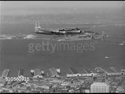 1948: SAN FRANCISCO BAY AREA: AERIAL Commercial Douglas DC-6 transport aircraft in flight with Yerba Buena Island BG. AERIAL San Francisco-Oakland Bay Bridge (officially James 'Sunny Jim' Rolph Bridge). Instructional Video