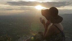 woman using smartphone from mountain top Stock Footage