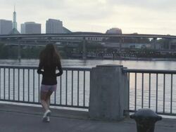 MS Shot of young female jogger does several takes of standing on water front facing city and then beginning her morning jog / Portland, Oregon, United States  Stock Footage