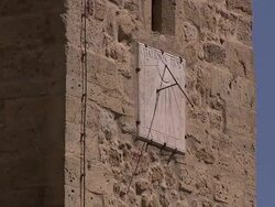 A sundial hangs from the side of a stone building. Stock Footage