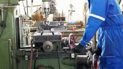 Manual worker working on drill in factory Stock Footage