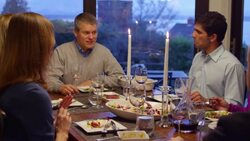 MS Family and friends sitting at dining room table together during dinner Stock Footage