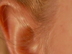 Close Up_tilt-down tilt-up - A hole pierces a woman's ear.   Stock Footage