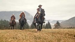 SLO MO Three herdsmen galloping across mountain meadow Stock Footage